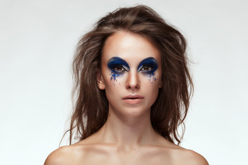 Woman with blue fantasy make up on eyes