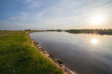 summer sunrise over the river with a fog