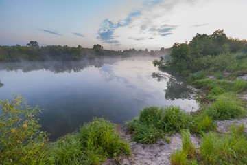 Obraz na płótnie Canvas summer sunrise over the river with a fog