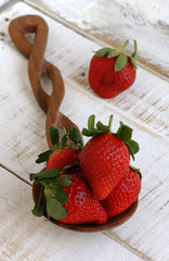 Large strawberries on a wooden spoon