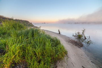 Fototapeta na wymiar summer sunrise over the river with a fog