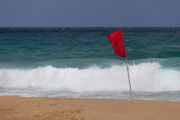 Red flag warning of dangerous seas for swimming on Karon beach, Phuket, Thailand