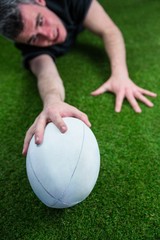A rugby player scoring a try