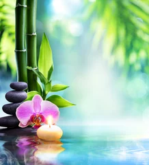 Wall murals Bathroom spa still life - candle and stone with bamboo in nature on water  