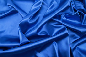 Soft folds of blue silk cloth.