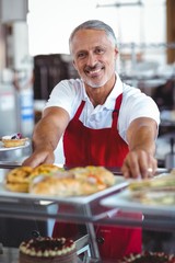 Barista smiling at camera behind counter