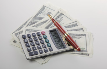 Business Charts with calculator, dollars money and pen on white