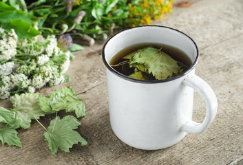 A mug of herbal tea (infusion) with dried black currant leaves