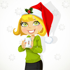 Cute girl in Santa hat hold cup of hot drink