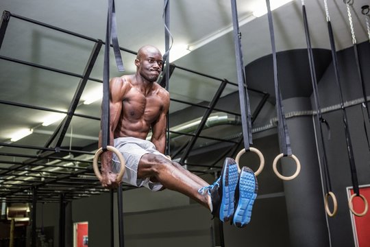 Young Bodybuilder lifting himself up and down 