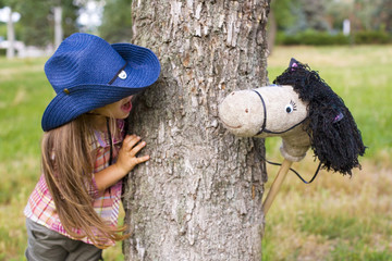 oung cowboy shirt and a toy horse