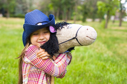 oung cowboy shirt and a toy horse