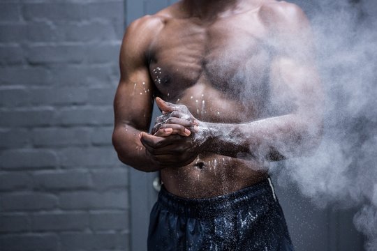 Young Bodybuilder shaking Chalk off his hands