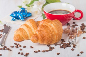 Fresh croissants with cup of hot coffee