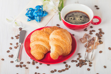 Fresh croissants with cup of hot coffee