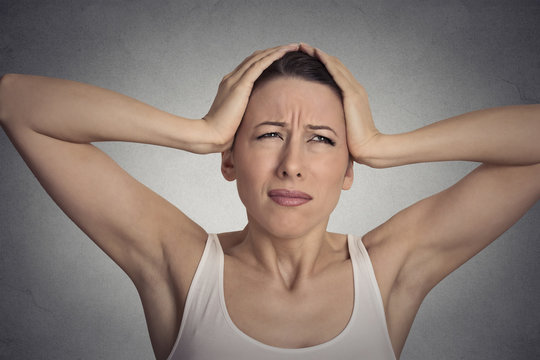 stressed sad young woman overwhelmed having headache