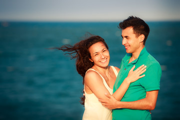 girl and guy play against mountains