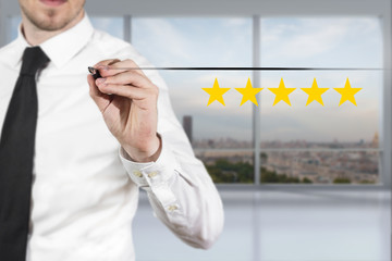 businessman drawing line in the air five rating stars