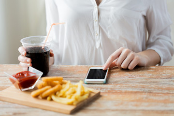 close up of woman with smart phone and fast food