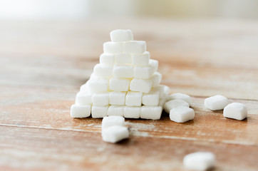 close up of white sugar pyramid on wooden table