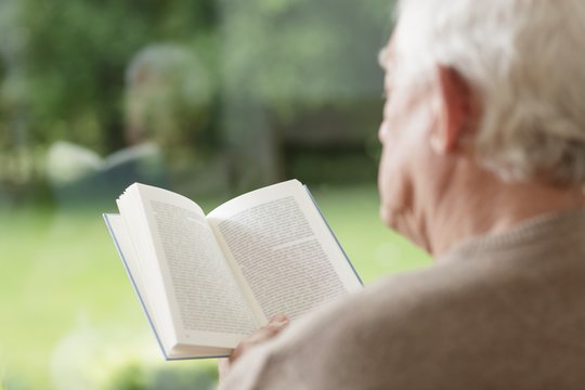 Elder man reading book