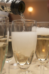 pouring the champagne in a glass
