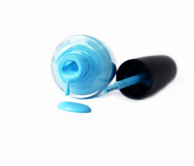 blue nail polish bottle with splatters isolated on white background