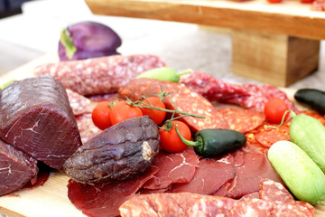 smoked meat products, vegetables on the table