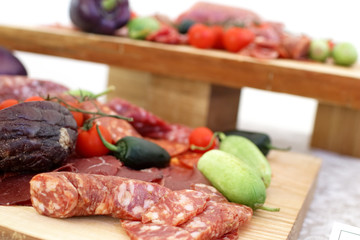 smoked meat products, vegetables on the table