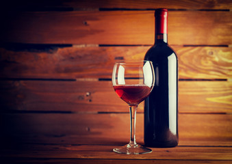 Wine glass and Bottle on a old wooden background