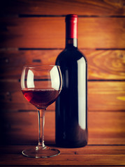 Wine glass and Bottle on a old wooden background