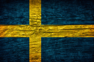 Vintage flag of Sweeden on wooden surface