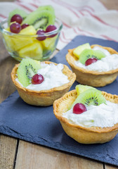 Homemade tartlets with whipping cream and fruits