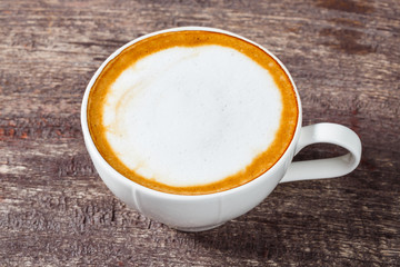 Coffee cup on old wooden table