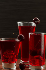 juice cherry with ripe berries on wooden background. A healthy diet