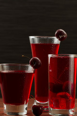 juice cherry with ripe berries on wooden background. A healthy diet
