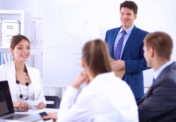 Fototapeta premium Beautiful young business people with colleagues discussing in