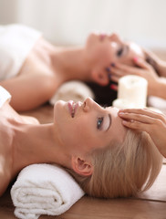 Two young beautiful women relaxing and enjoying at the spa