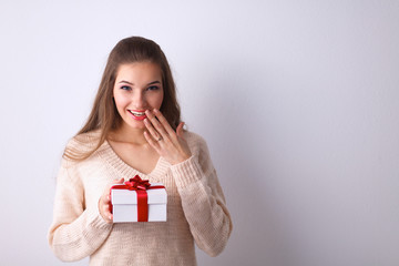 Young woman happy smile hold gift box in hands,standing over