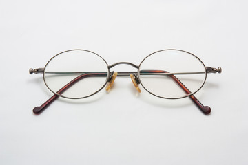 Old eye glasses on a white background.