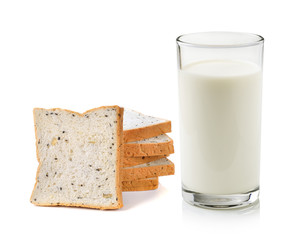 Glass of milk and whole wheat bread isolated on white background