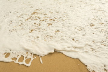 Sea wave and many foot print on the beach background