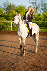 Horsewoman at hippodrome and blue sky