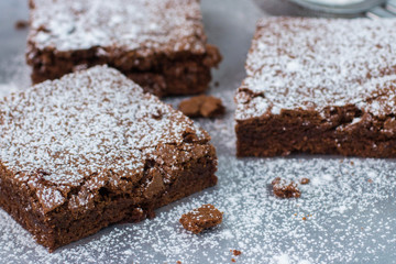 Fototapeta na wymiar Brownie. Chocolate cakes with powdered sugar