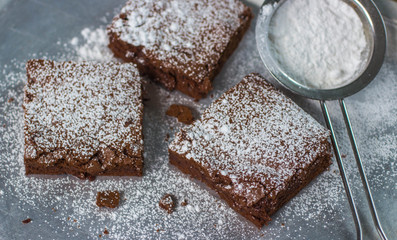 Brownie. Chocolate cakes with powdered sugar