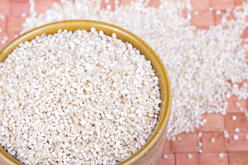 barley groats in a brown bowl 