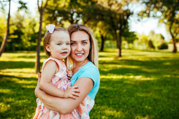 Fototapeta premium Happy mom and daughter smiling at nature.