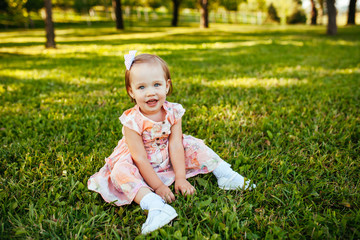 Cute little girl on the meadow in summer day.