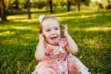 Cute little girl on the meadow in summer day.