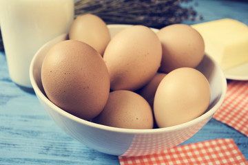 milk, eggs and butter on a blue rustic surface, with a filter ef